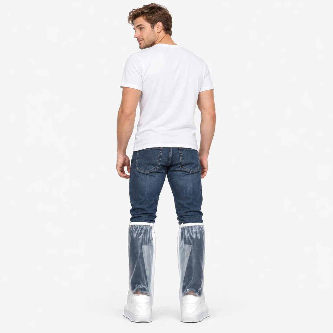 Back view of a man in a white t-shirt and jeans wearing clear tall overshoes with zippers over white sneakers. 4