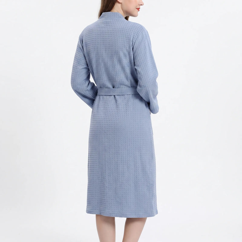 Back view of the blue waffle-textured robe on a model, showing the shawl collar and the belt across the back. 3