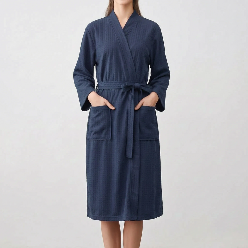 Model wearing the robe in dark navy, hands in the patch pockets, belt tied in a bow at the waist. 8