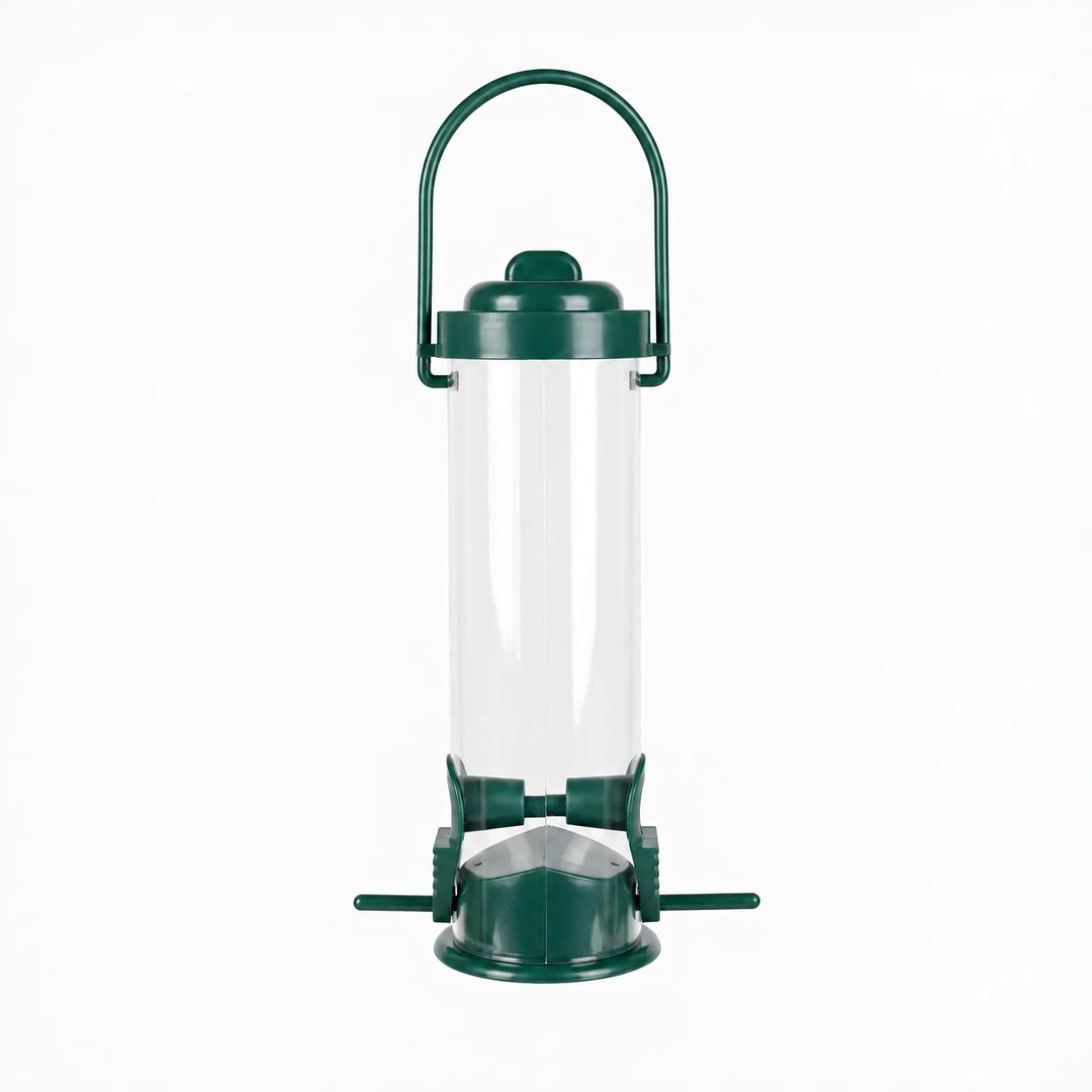 Empty clear tube bird feeder with dark green lid, arched carry handle, two feeding ports and small perches, shown against white. 1