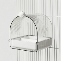 Side view of the bath with a white base and flower-shaped screw knob, fixed to white cage bars. 4