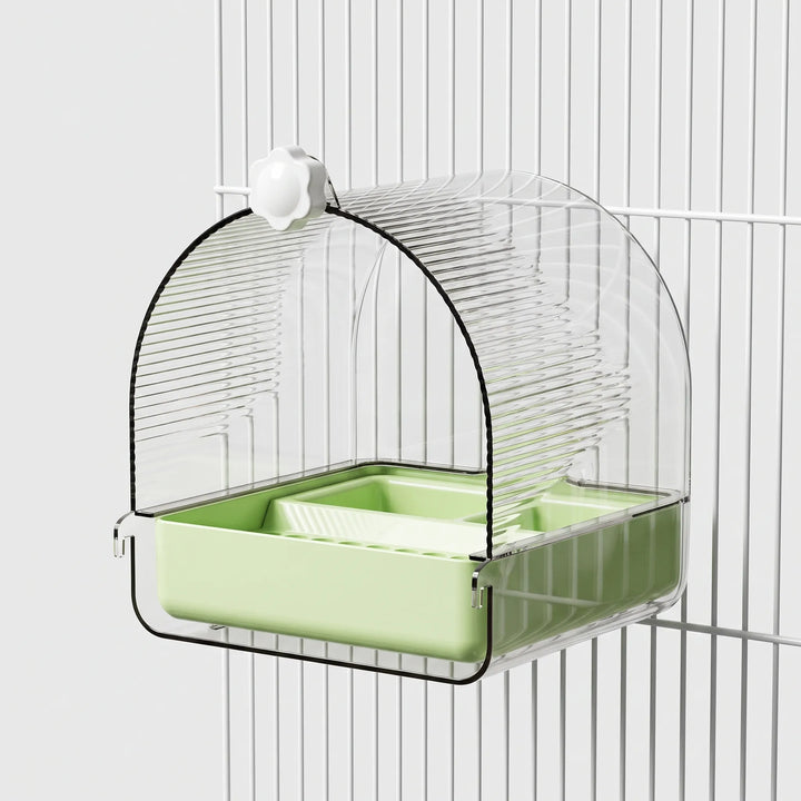 Bath with a pale green base and white knob, hooked onto white cage bars. 6