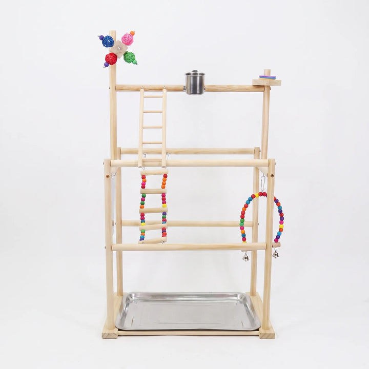 Front view of a multi-tier wooden bird playground on a plain white background, with beaded ladder, swing, steel cup and tray. 1