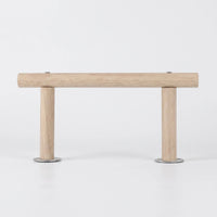 Side view of the wooden perch on a plain white background, a long horizontal rod held up by two short legs with metal washers. 1