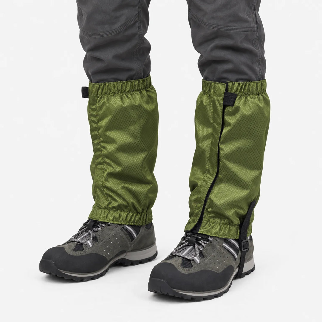 Olive green ripstop gaiters with elastic cuffs and under-boot strap, worn over grey hiking shoes against a plain white background. 2