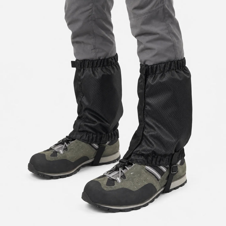 Black ripstop gaiters with zip closure and elastic hems, worn over green hiking shoes against a white background. 5