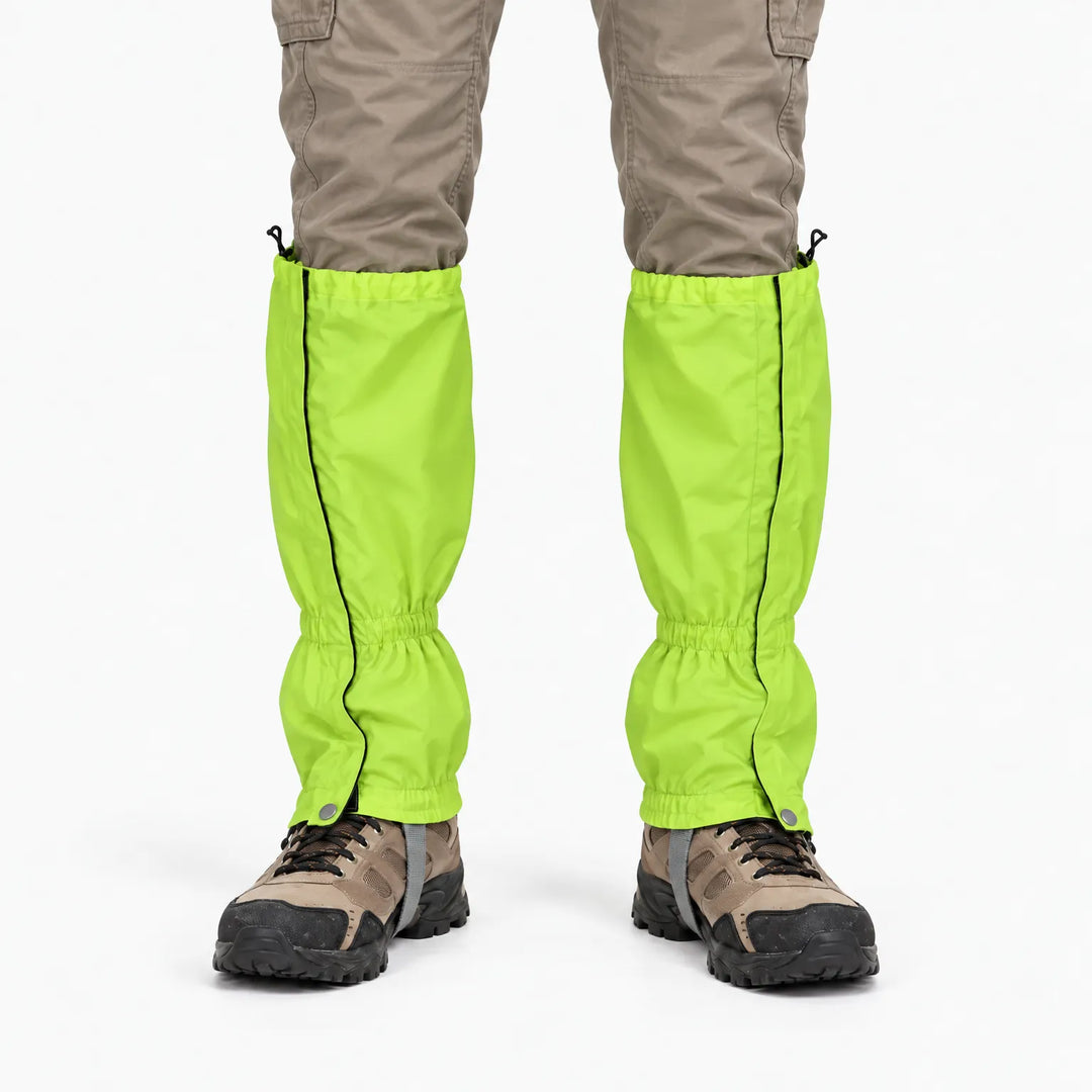 Front view of bright lime green gaiters worn over hiking boots with khaki cargo trousers, showing side zips and snap fasteners. 7