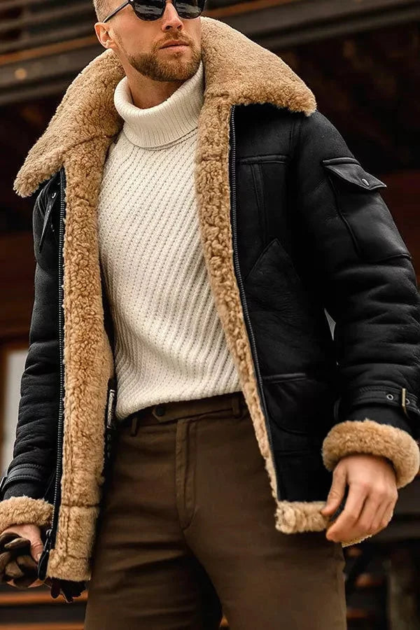 Black version of the shearling-lined jacket worn open over a cream ribbed polo-neck and brown trousers 5