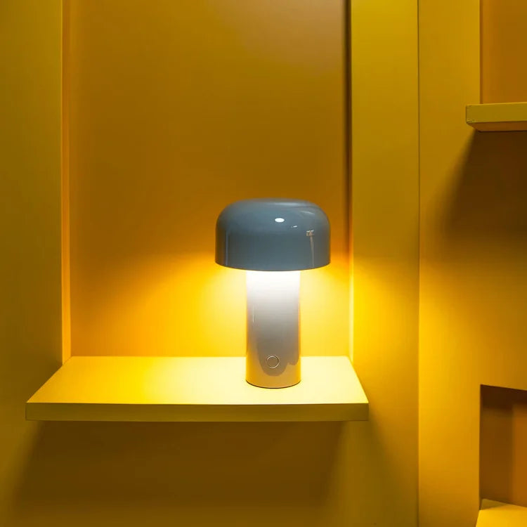 Blue-shaded mushroom lamp glowing brightly on a shelf in a yellow alcove 12