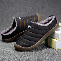 Black quilted slippers with orange stitching, one tilted to show the fleece-lined opening 9