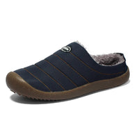 Single navy blue quilted slipper on white, showing fleece lining and chunky brown sole 15